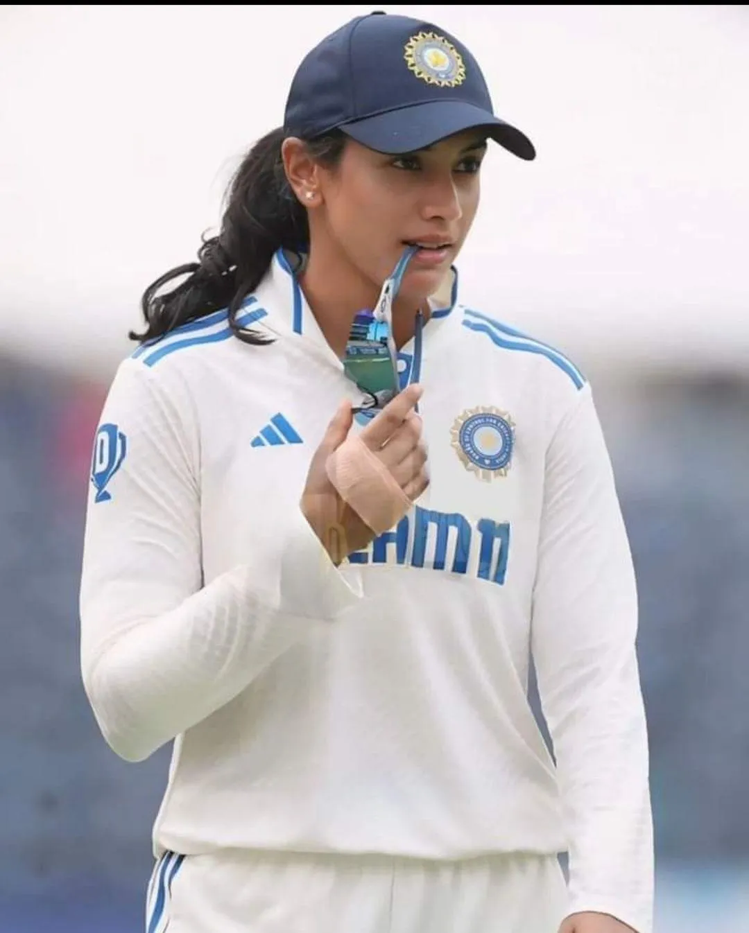 Smriti Mandhana posing with an Indian cap wallpaper