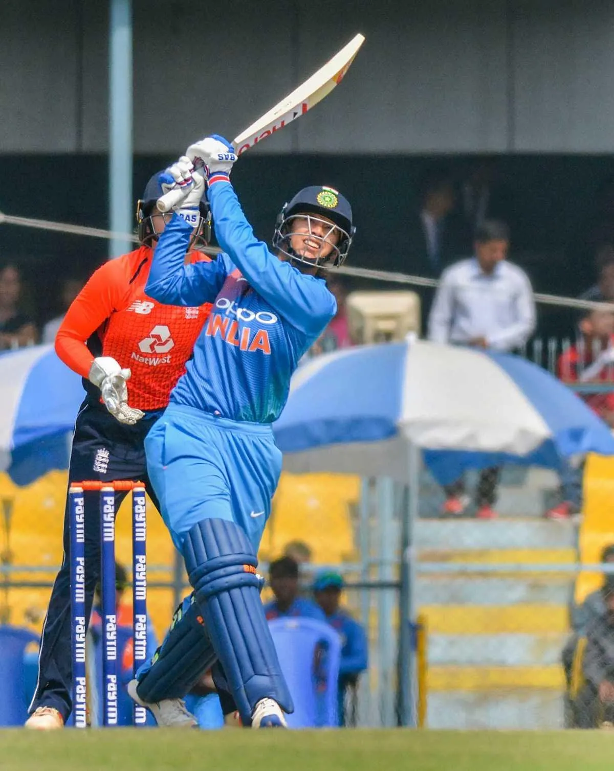 Smriti Mandhana practicing with bat on the field wallpaper