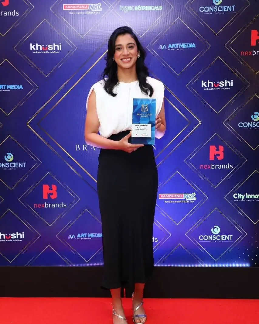 Smriti Mandhana presenting at an event with formal attire