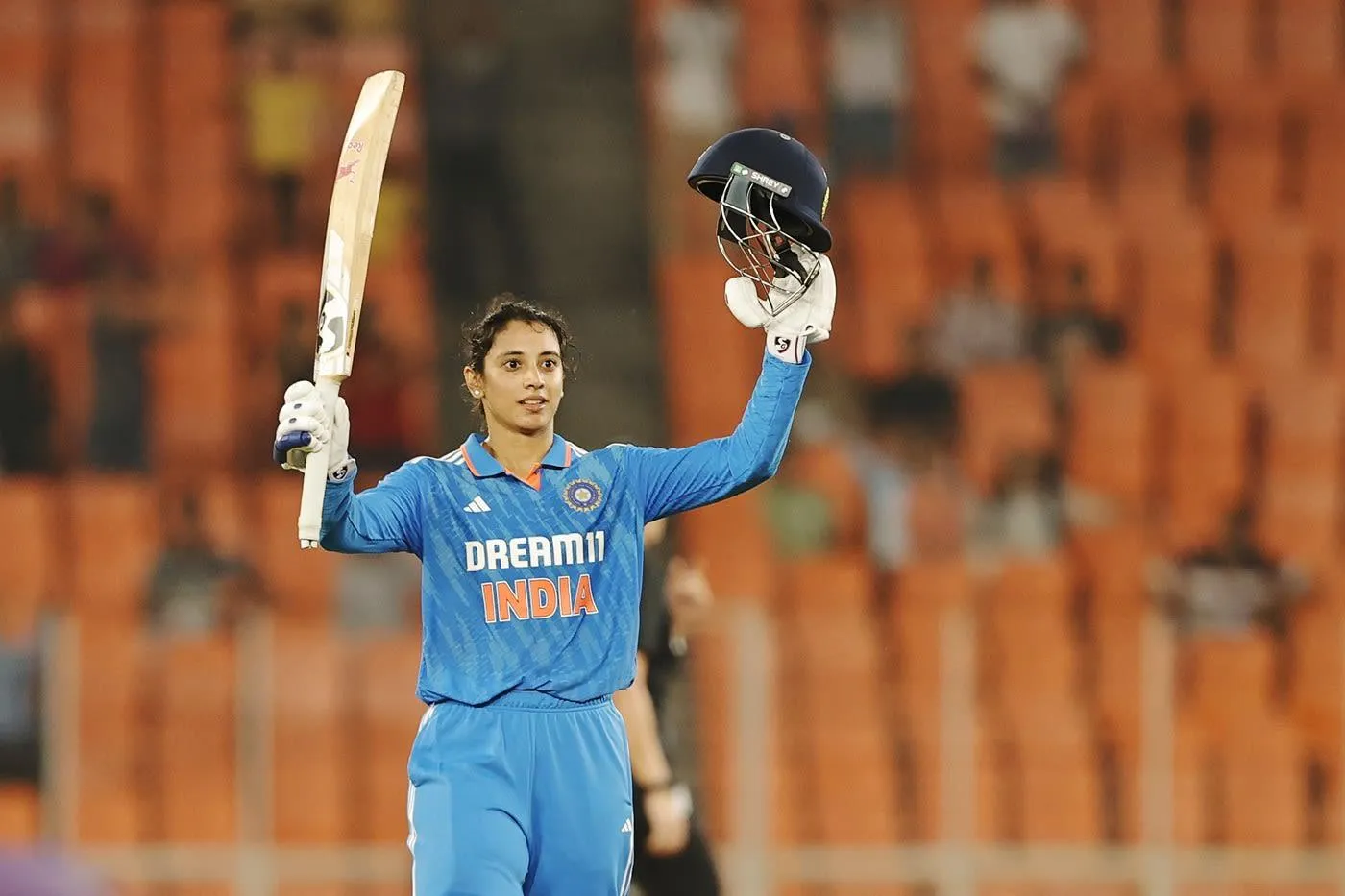 Smriti Mandhana raising her hands in a victorious moment