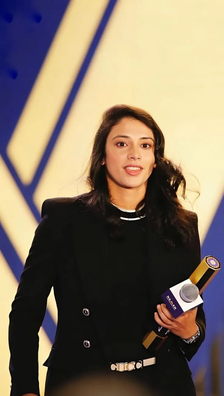 Smriti Mandhana receiving an award on formal stage