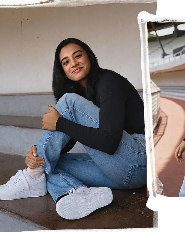 Smriti Mandhana relaxing and smiling in a casual spot