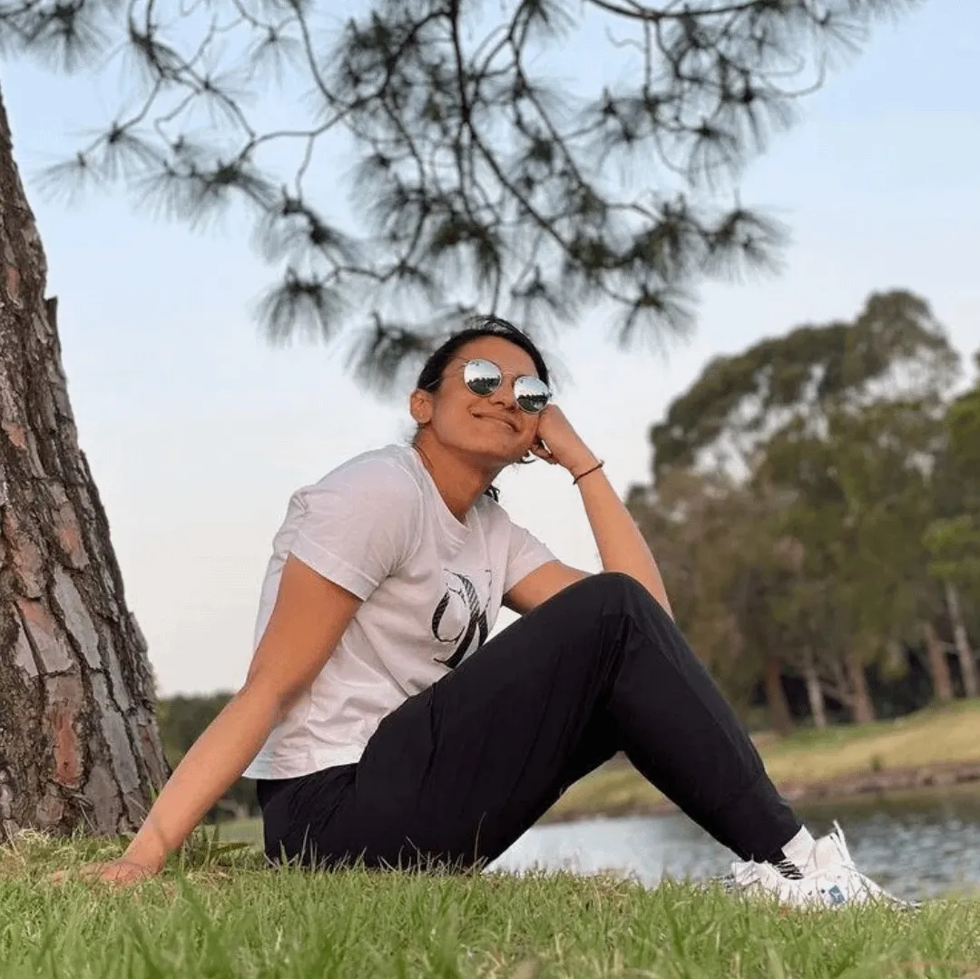 Smriti Mandhana relaxing outdoors sitting on the grass