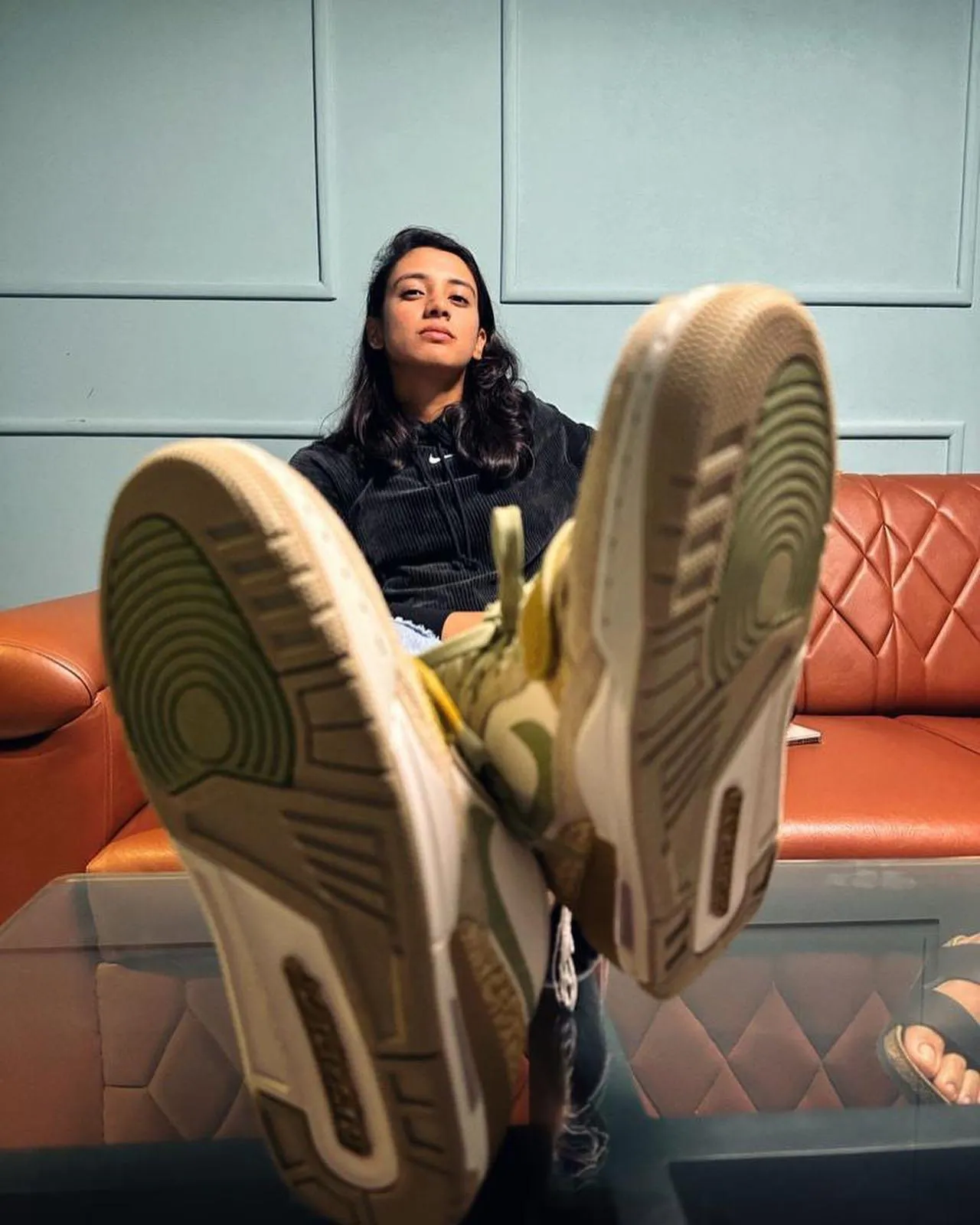 Smriti Mandhana resting with feet up during training
