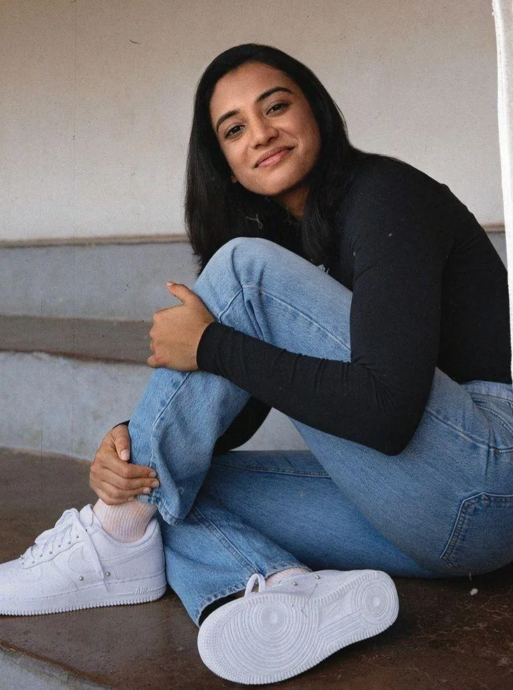 Smriti Mandhana sitting casually with a calm expression