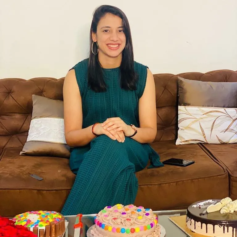 Smriti Mandhana Sitting on Sofa with Sweets Displayed