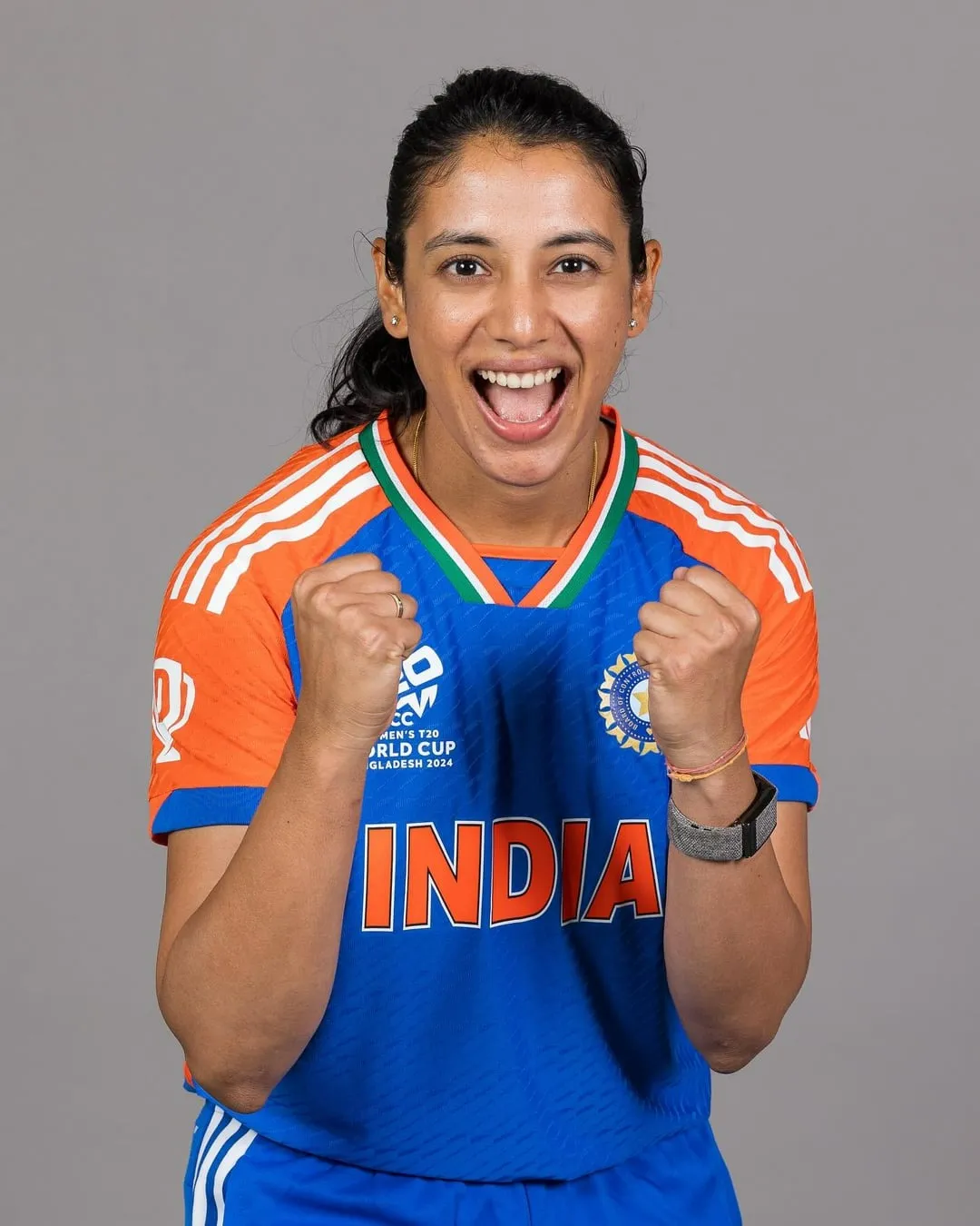 Smriti Mandhana smiling after a successful match