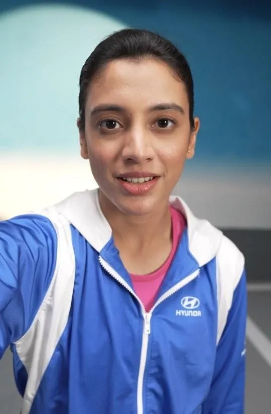 Smriti Mandhana Smiling in Blue Cricket Jersey wallpaper