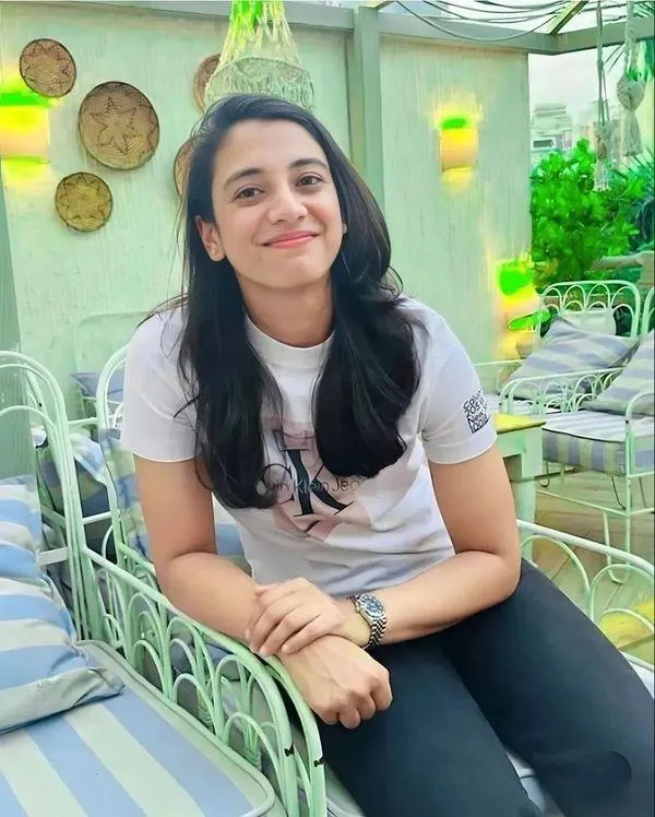 Smriti Mandhana smiling indoors in casual conversation