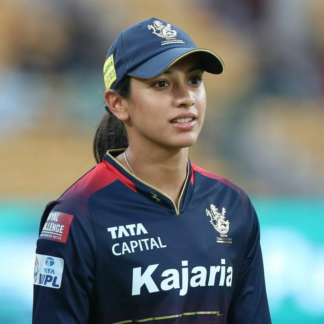 Smriti Mandhana standing focused wearing team jacket