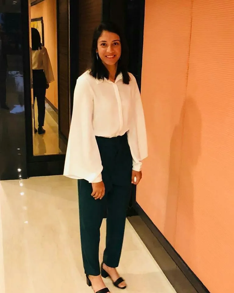 Smriti Mandhana Standing in Hallway Wearing Formal Attire