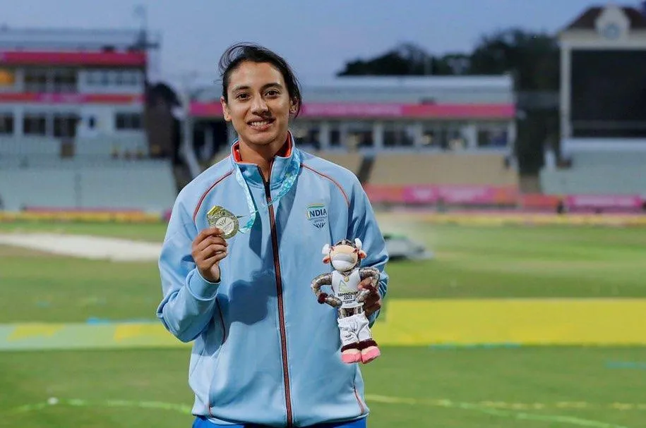 Smriti Mandhana Standing on Field in Blue Cricket Jersey