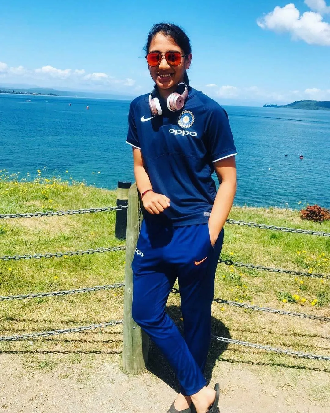 Smriti Mandhana standing sea wearing a casual blue outfit