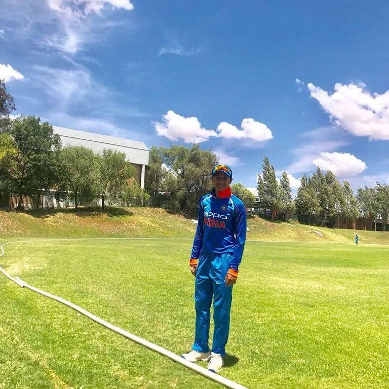Smriti Mandhana standing tall in her cricket uniform