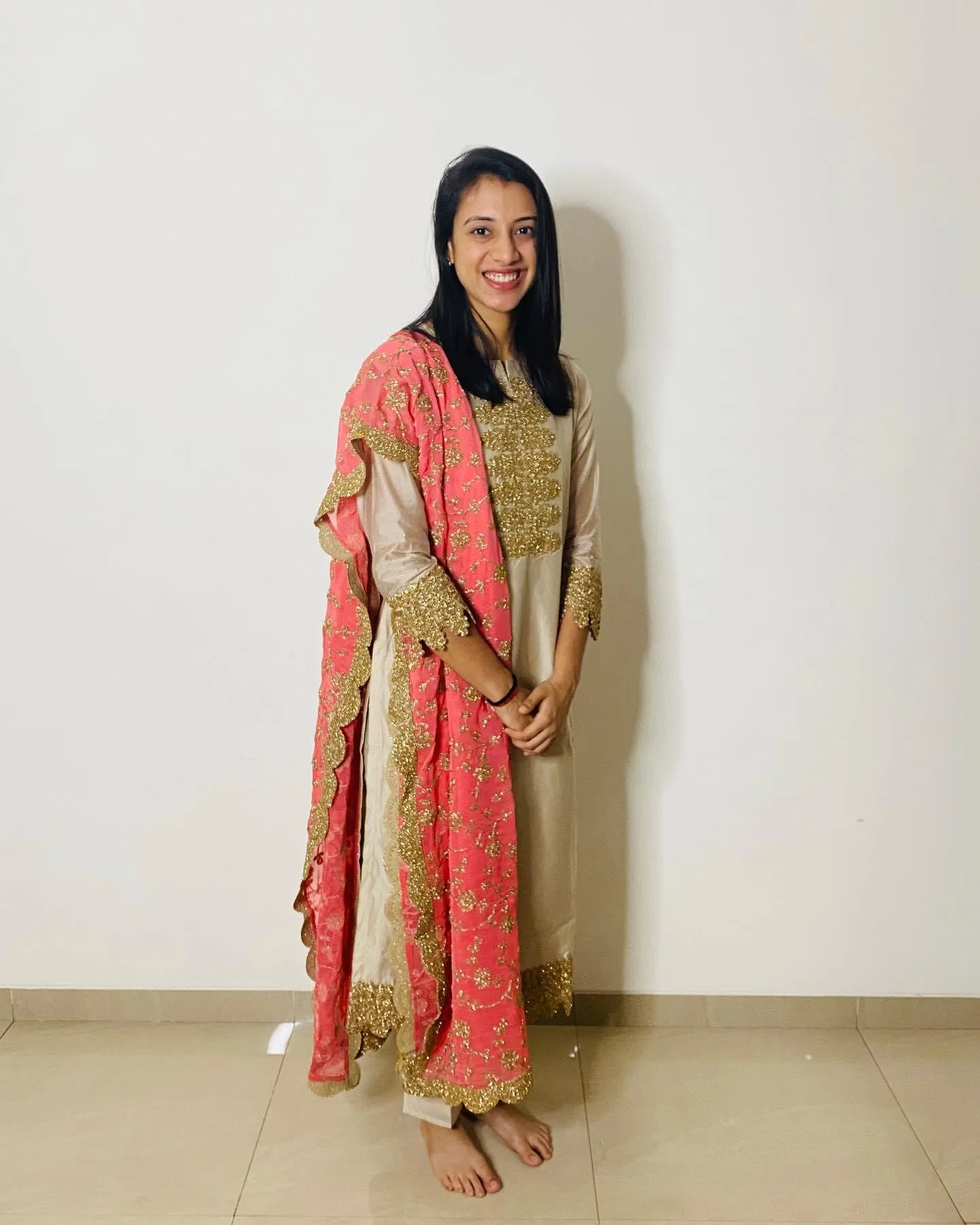 Smriti Mandhana striking a pose in a saree wallpaper