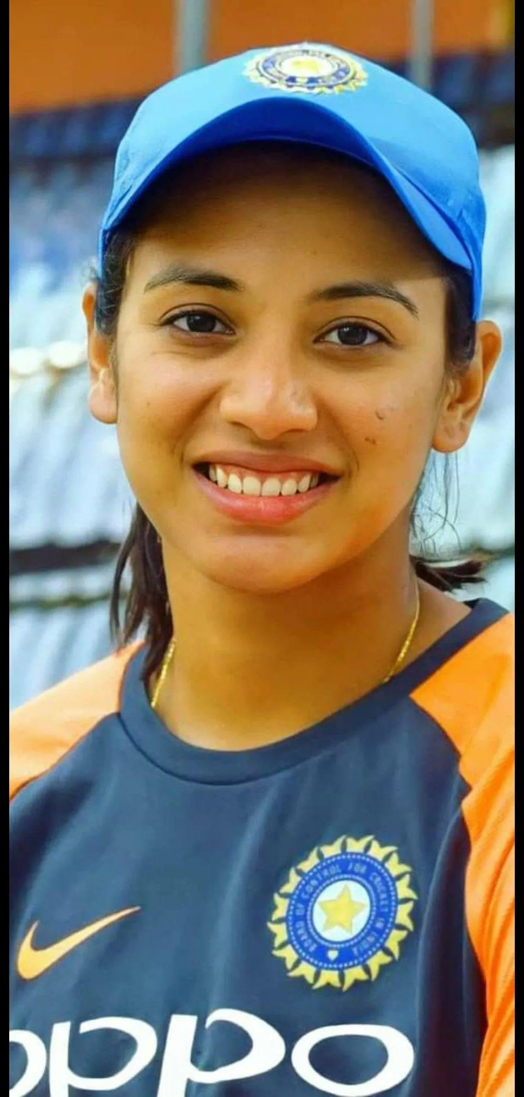 Smriti Mandhana Striking Pose with Sports Gear wallpaper