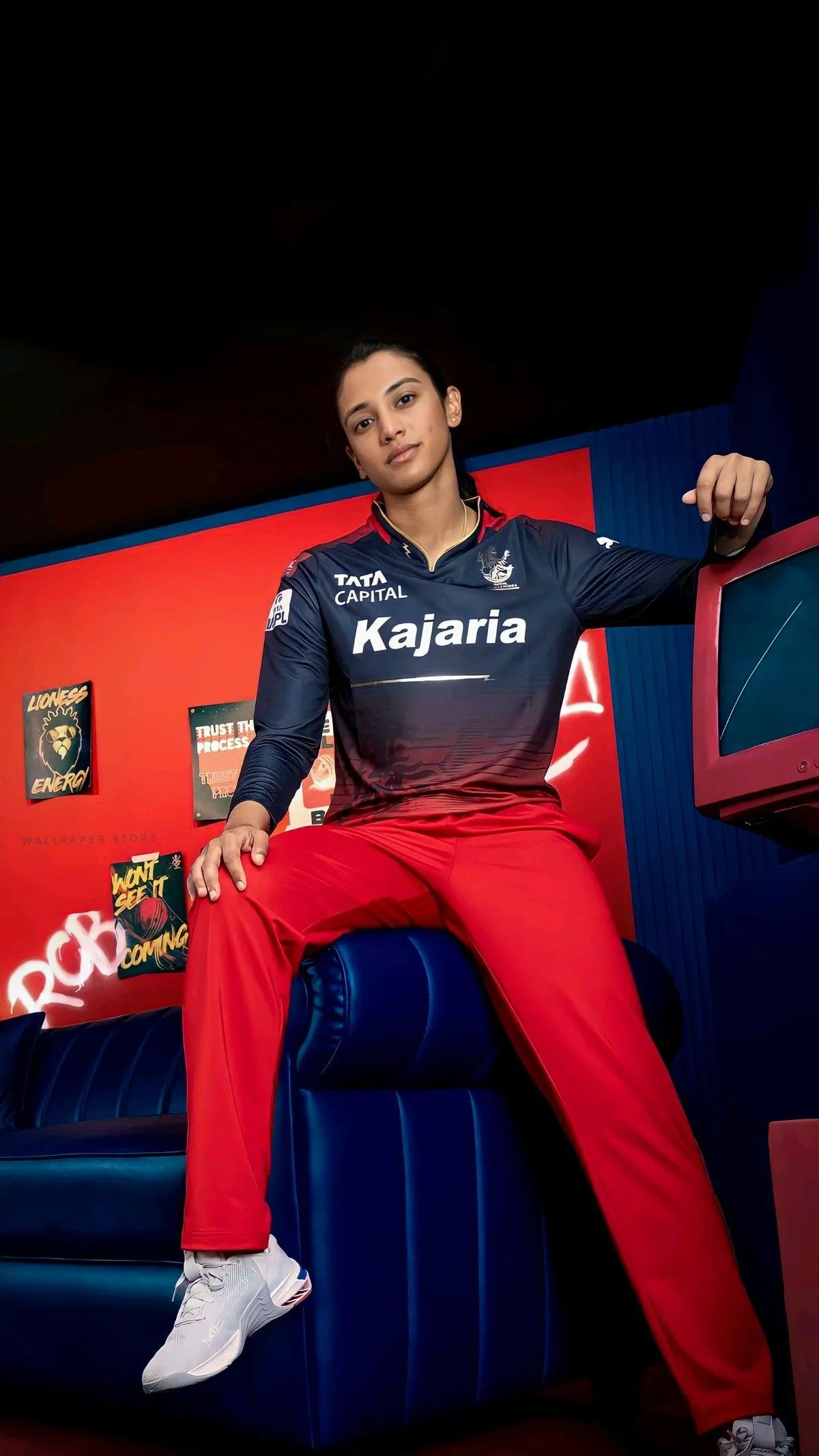 Smriti Mandhana swinging her bat during a match wallpaper