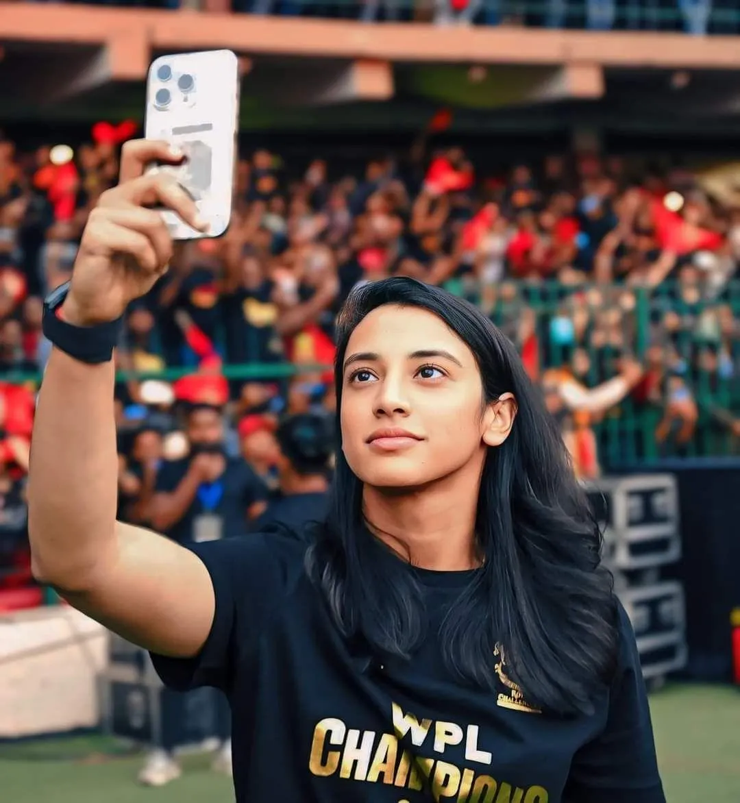 Smriti Mandhana taking a selfie with fans in the stadium
