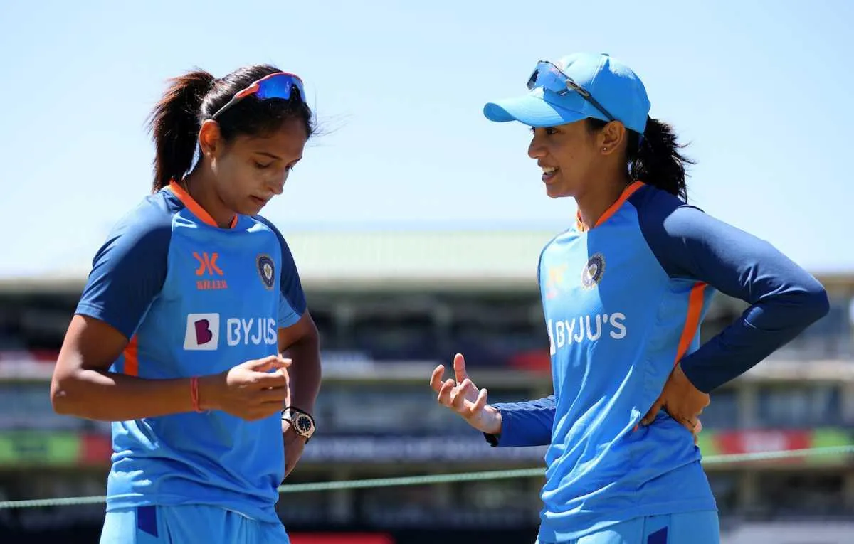 Smriti Mandhana talking with teammate on cricket field