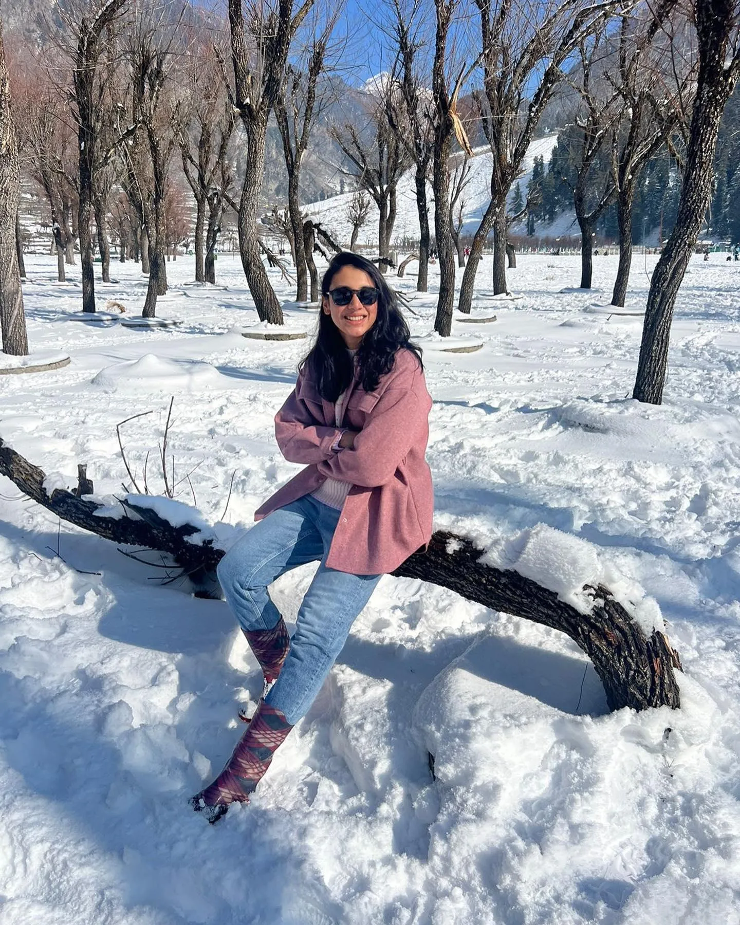 Smriti Mandhana walking in snowcovered park in winter coat