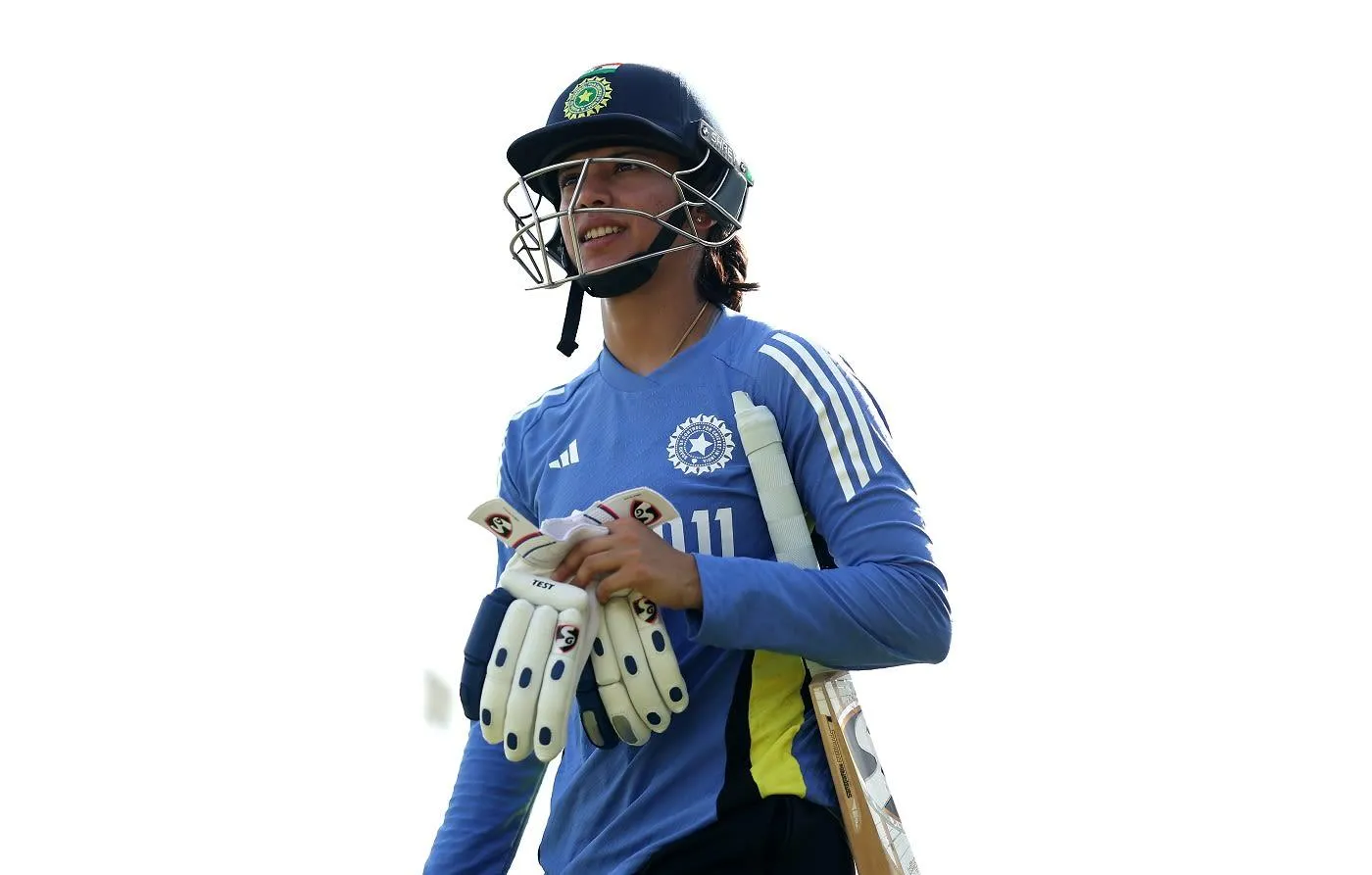 Smriti Mandhana walking with bat and gloves in hand