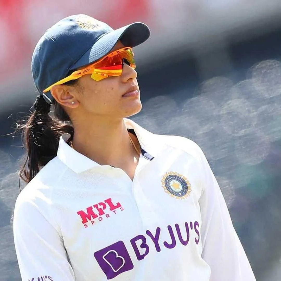 Smriti Mandhana wearing a cap while focusing on a game
