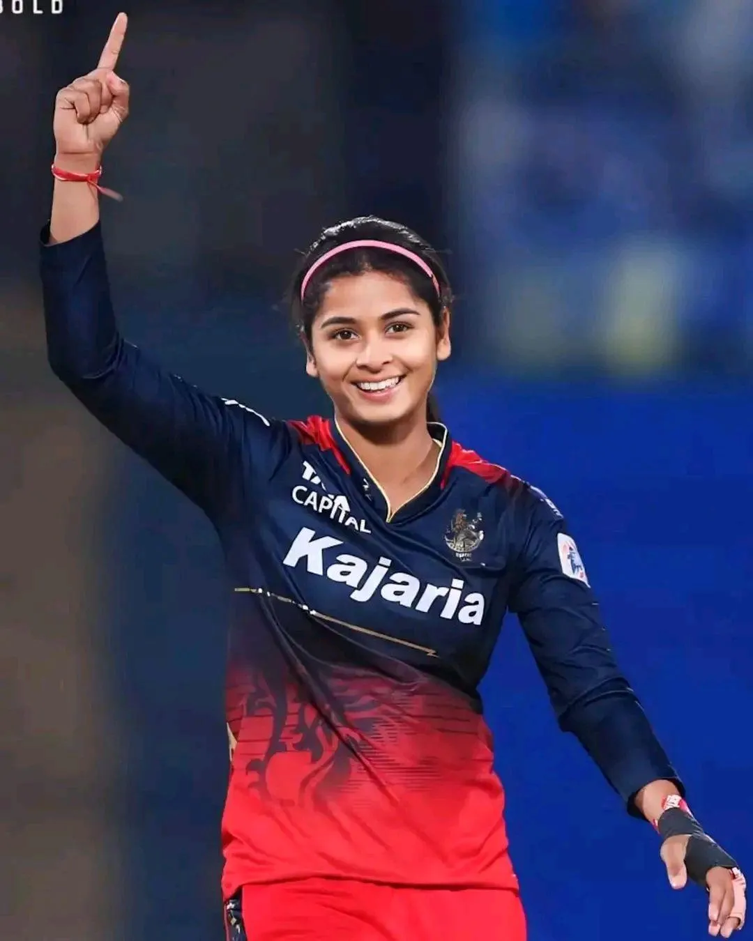 Smriti Mandhana with hands raised in a celebratory gesture