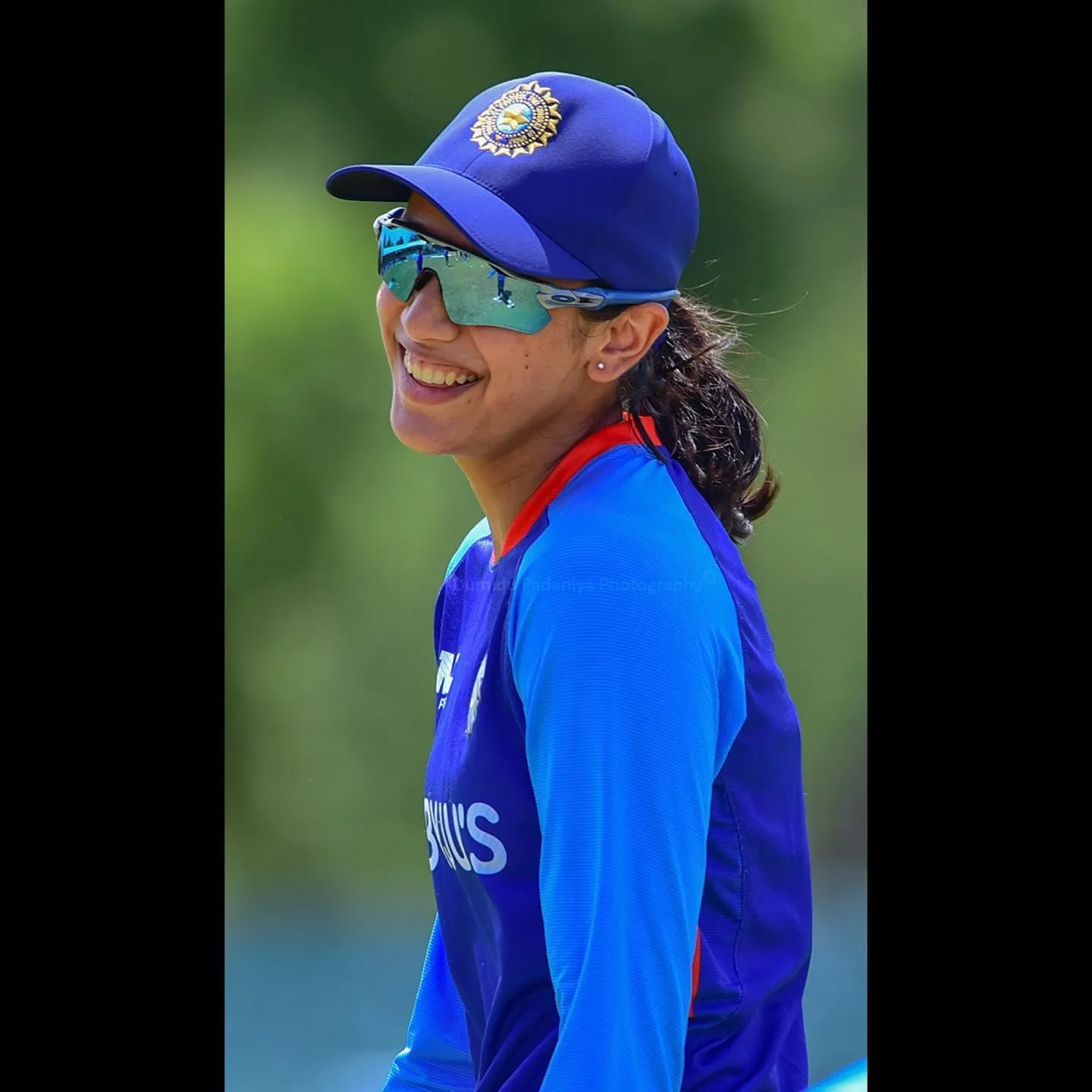 Smriti Mandhana with her hair tied in a cricket match pose
