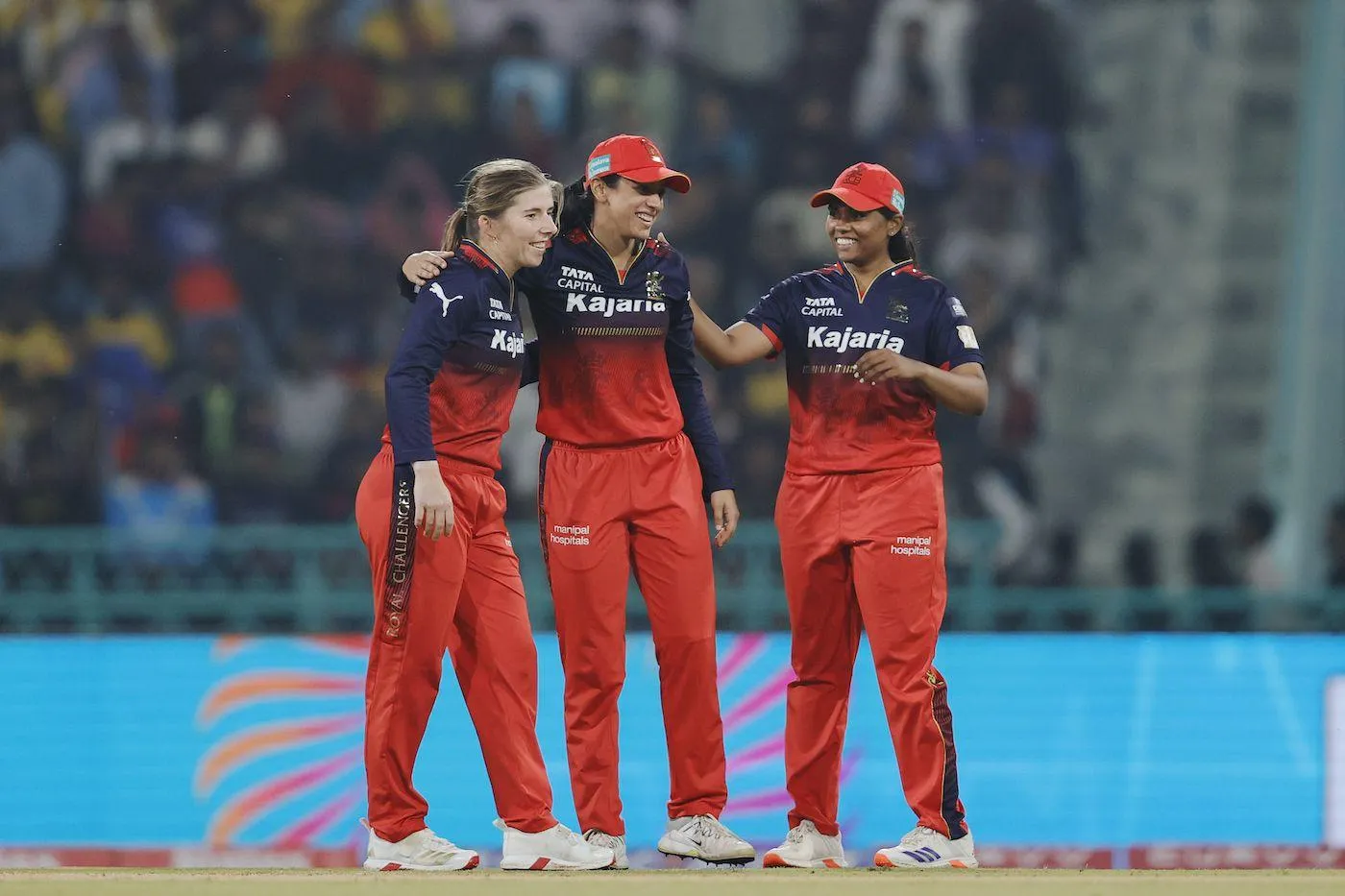 Smriti Mandhana with her team celebrating a win wallpaper