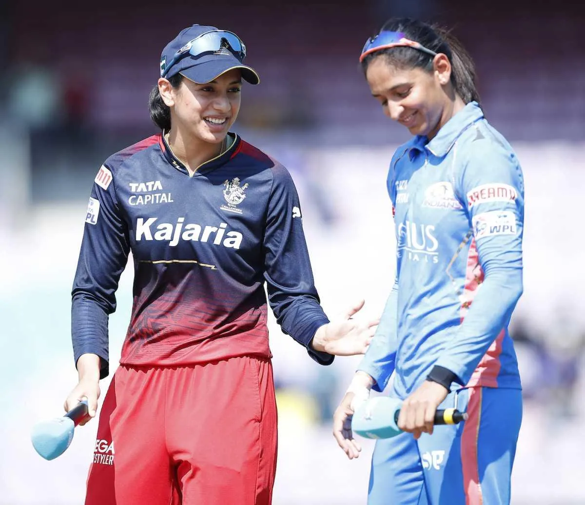 Smriti Mandhana with her teammate during a cricket match