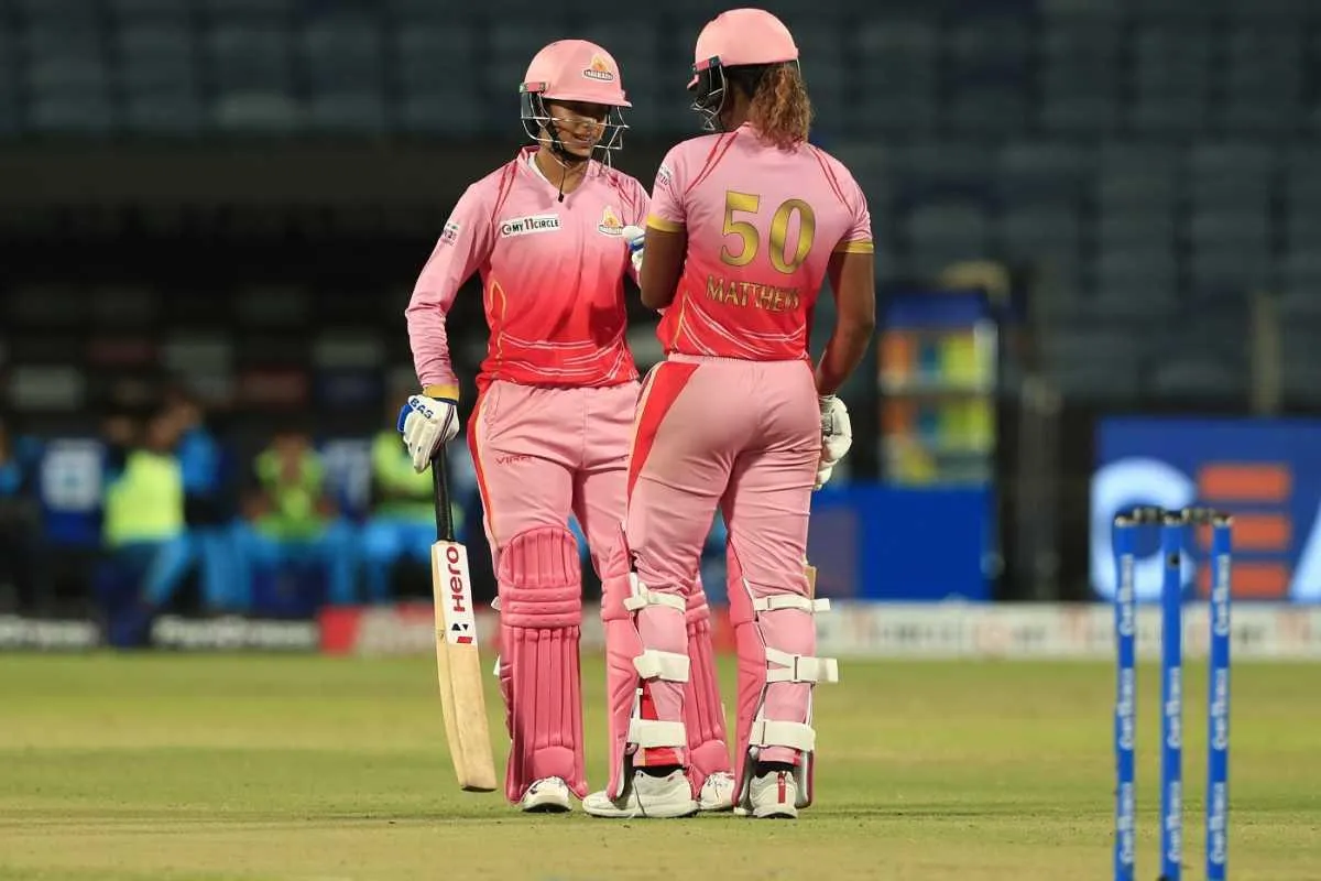 Smriti Mandhana with her teammates in a cricket match