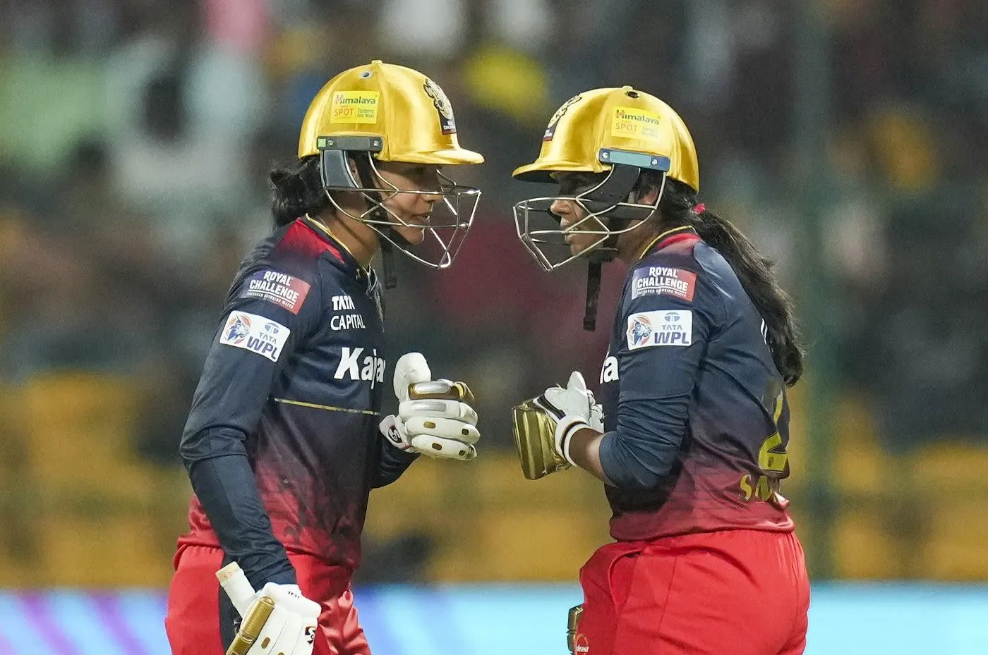 Smriti Mandhana with teammates sharing a moment of joy