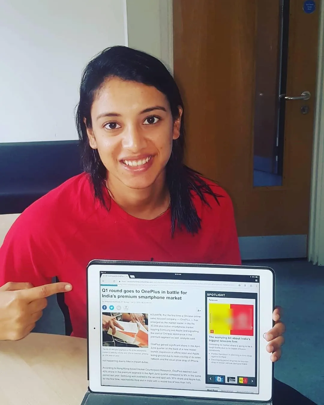 Smriti Mandhana working on a laptop during a busy day
