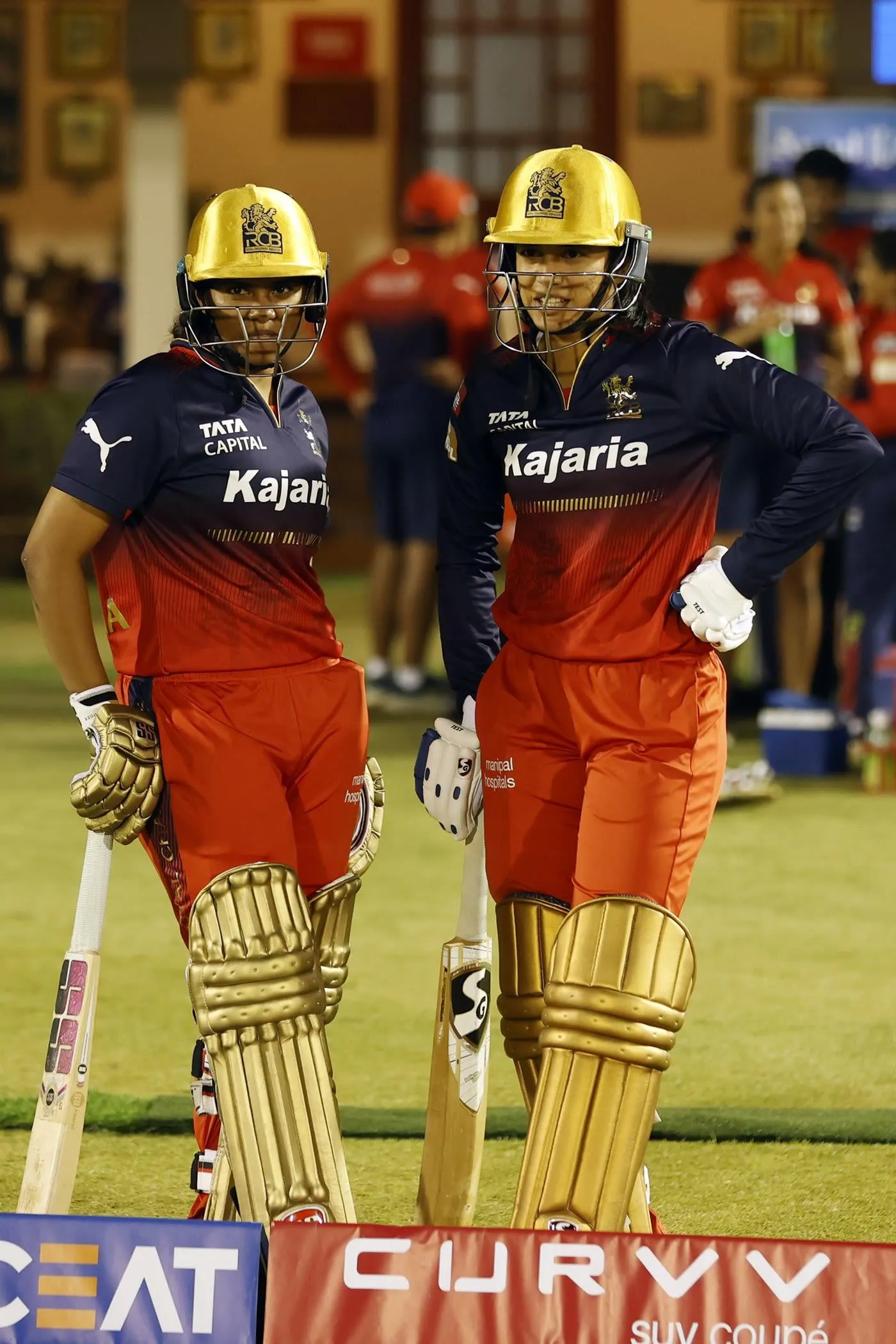Smriti on the cricket ground with teammates in gear