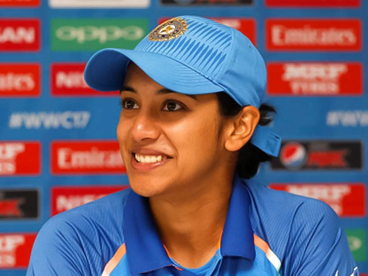 Smriti Smiling Happily in Blue Team Uniform wallpaper