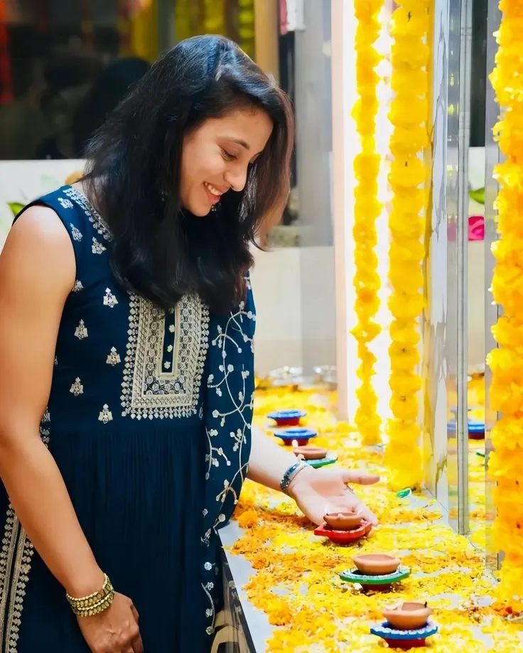 Smriti Smiling While Arranging Diyas for Diwali Celebration
