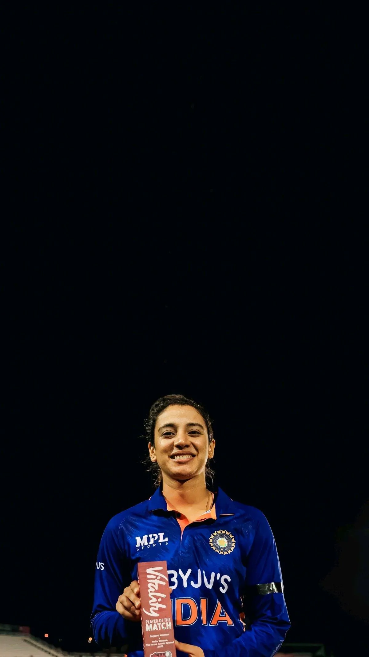Smriti Standing Tall and Confident in Blue Jersey wallpaper