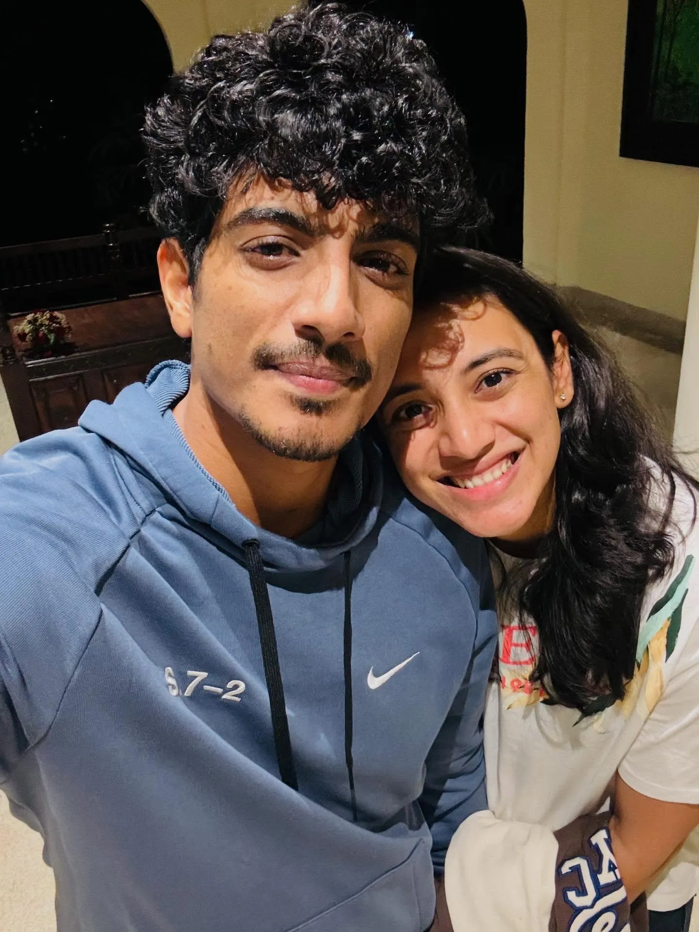 Smriti with a friend posing happily in a sports jacket