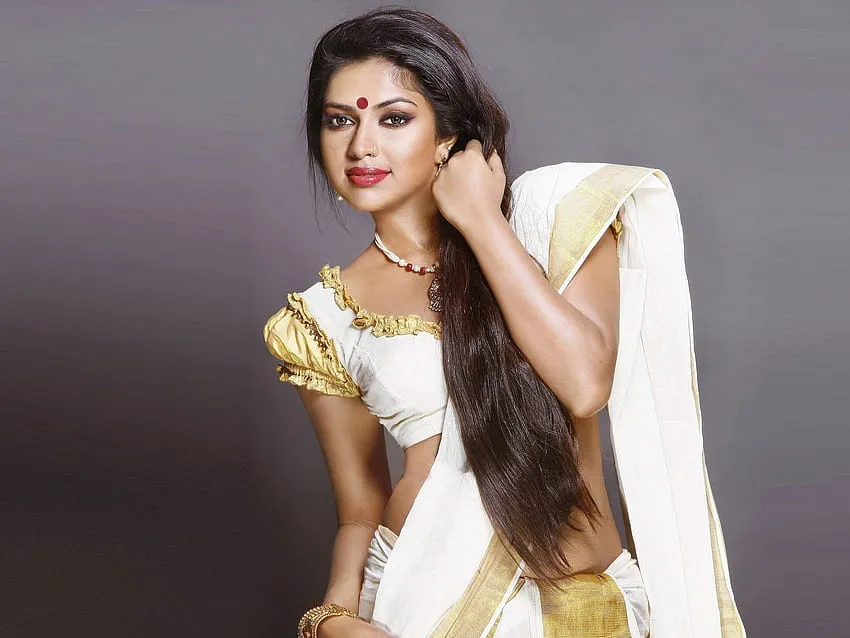 Actress Amala Paul in a Kerala saree standing in the studio