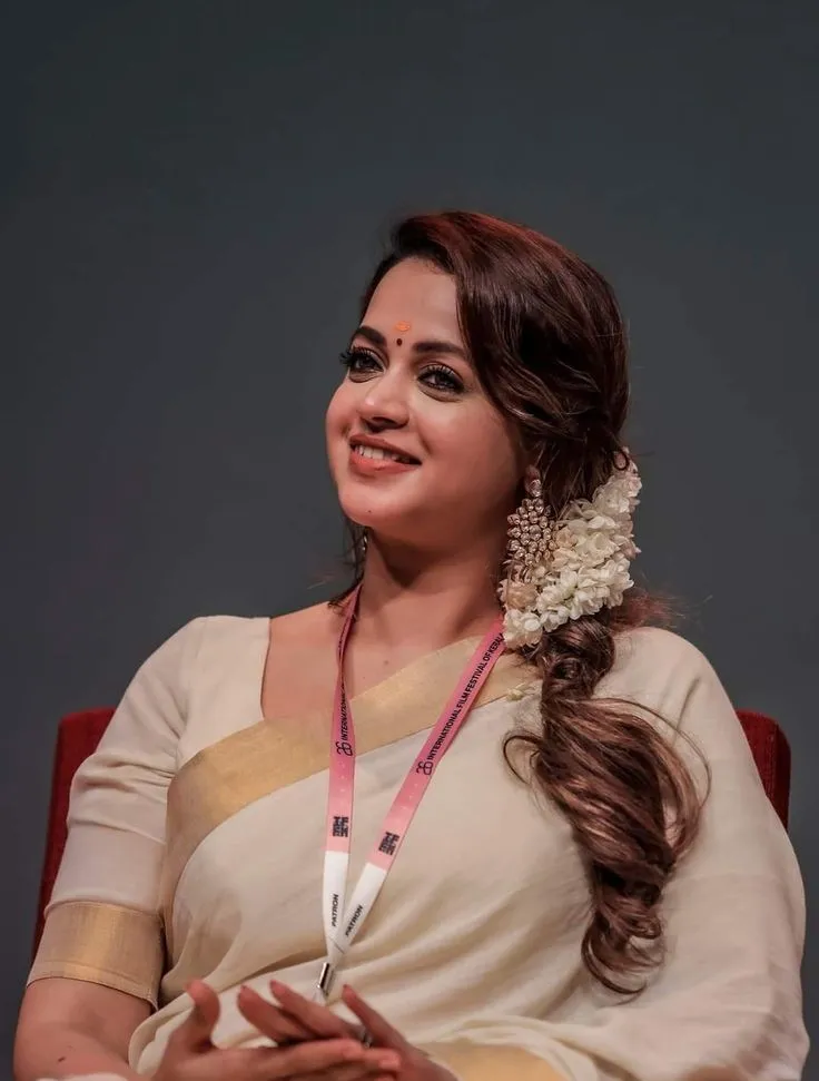 Actress Bhavana in a Kerala saree sitting at the event image