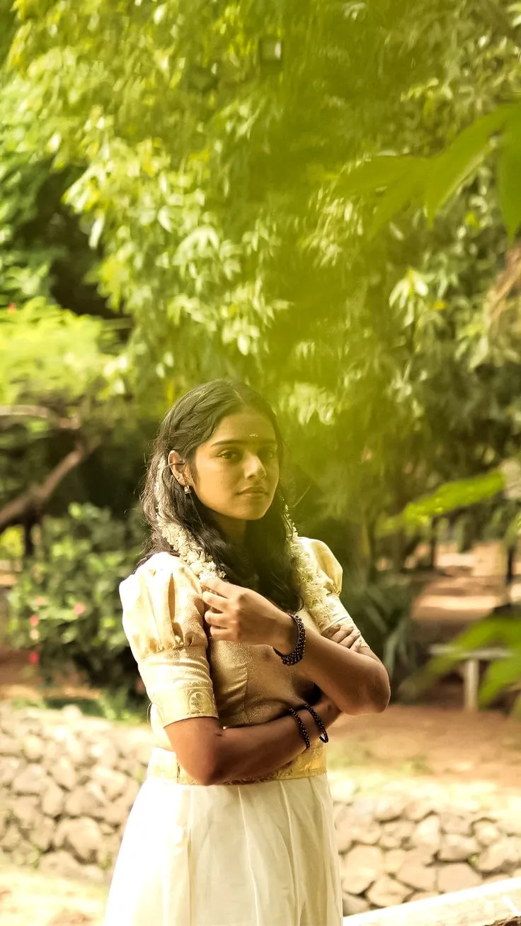 Akshathaa Ajit in a white outfit standing in the park image