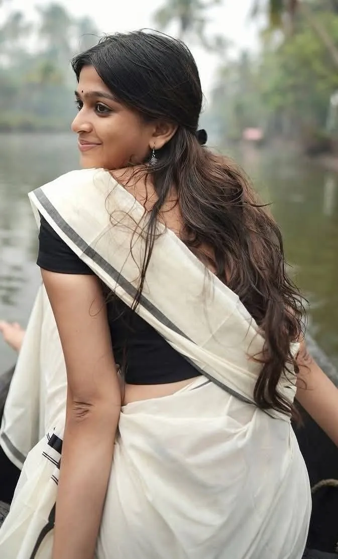 Ananthika Sanilkumar in a white saree and black blouse image