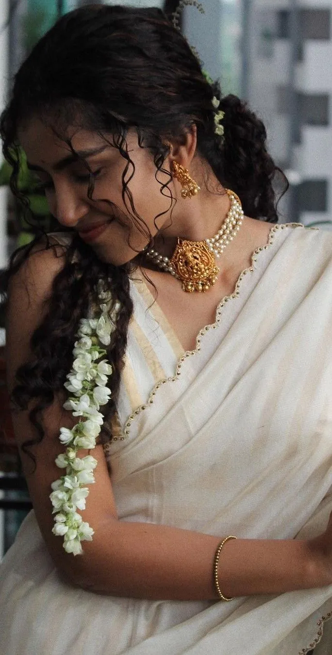 Anupama Parameswaran in a Kerala saree with a flower in hair