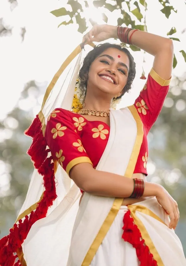 Anupama Parameswaran in a white and dress dress with a smile