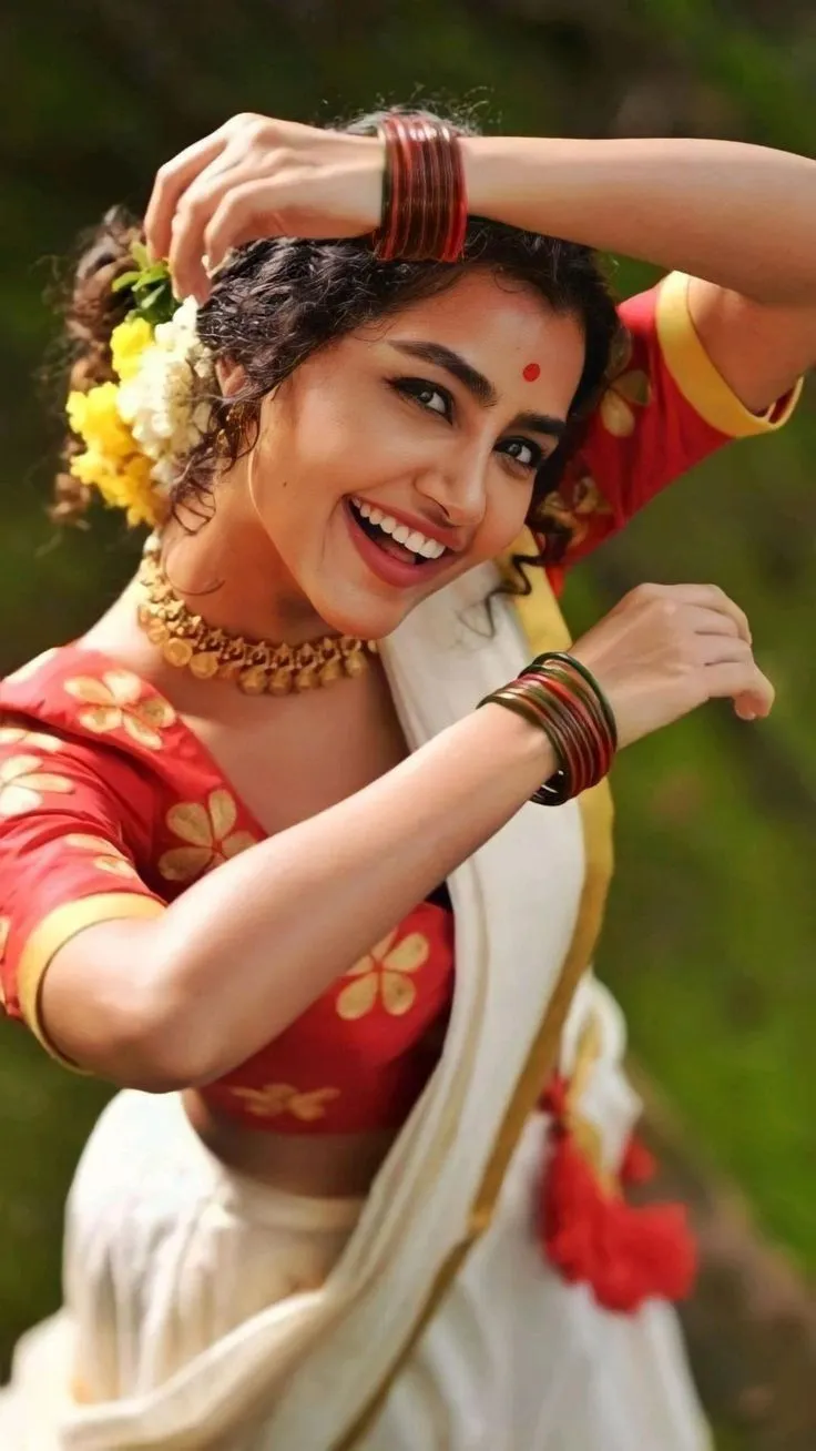 Anupama Parameswaran in a white dress with a red blouse