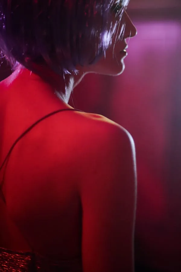 Artistic Back View of a Woman with Neon Purple Lighting