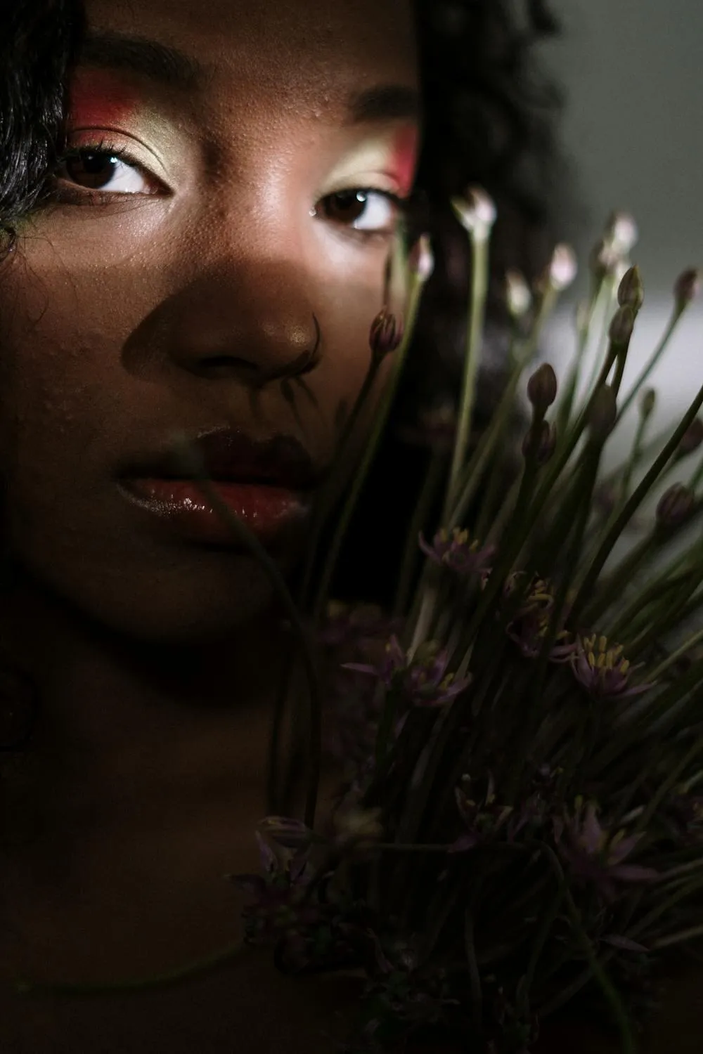 Artistic Close Up Portrait of a Woman with Flowers Held