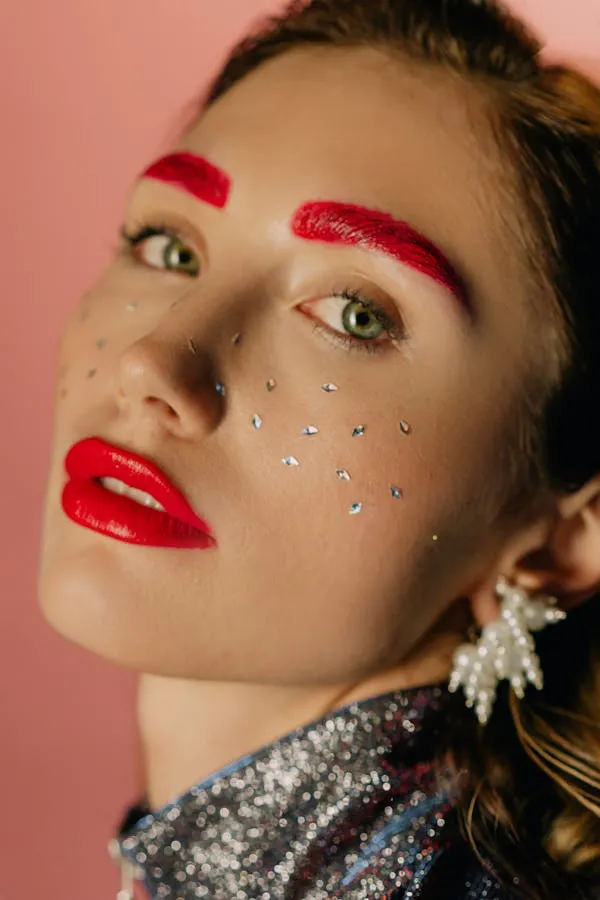 Artistic Makeup Look with a Bold Red Eyebrows and Crystals