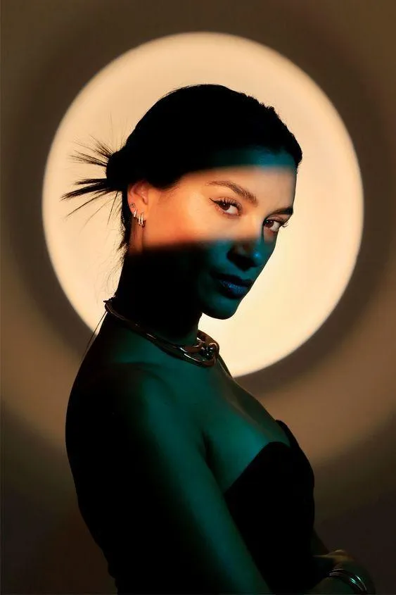 Artistic Portrait of a Woman in Green Light and Shadows