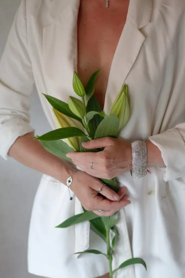 Artistic Shot of a Woman Holding Green Plant in Cozy Setting